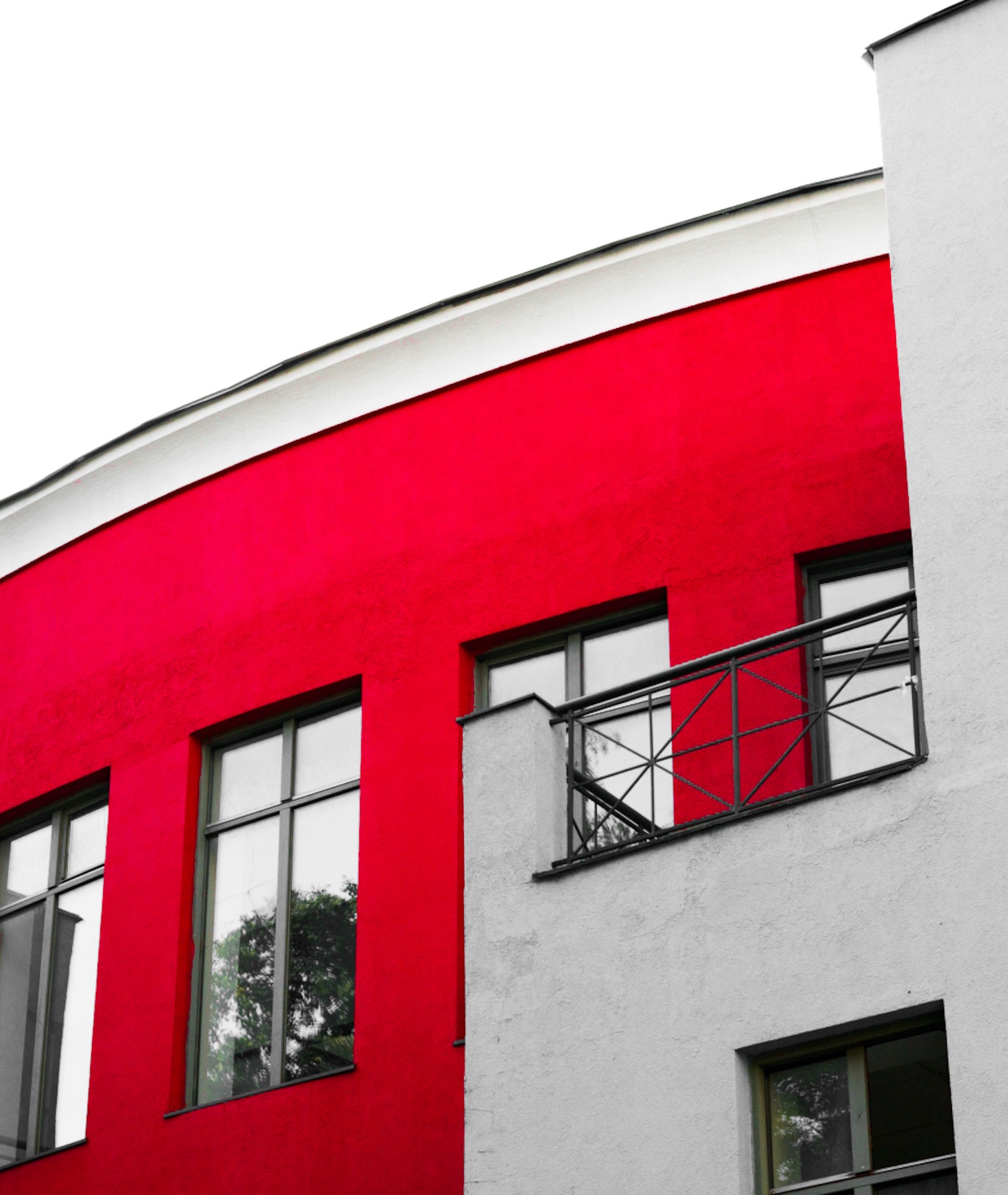 Bold red and white residential exterior facade with crisp painted finish